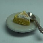 Slice of Lemon Meringue Pie on Plate with Fork